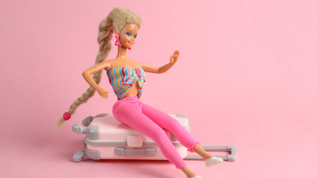 Barbie-Puppe sitzt auf einem Koffer (über cozmo news)