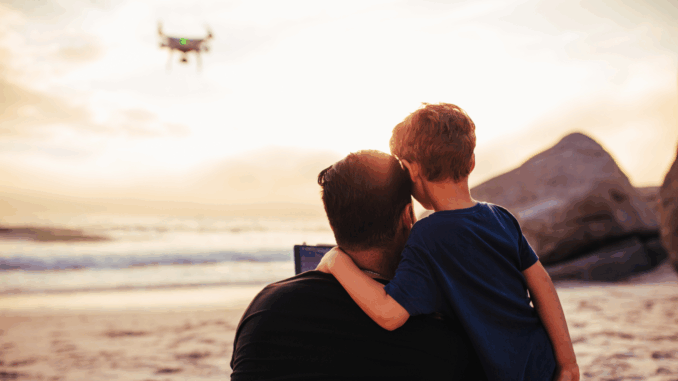 Vater mit Kind und Drohne (über Jacob Lund)